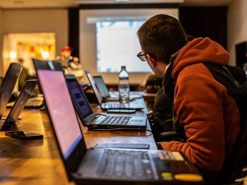 Man sitting at laptop in classroom